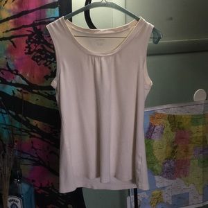 Off white, loose fitting sleeveless blouse.